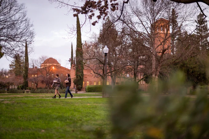 Two students walk on Chico State campus during winter break.

