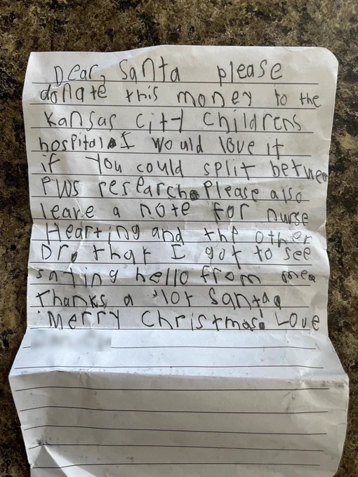 A photo of a lined piece of white paper with a note written on it by a child. The note says "Dear, Santa please donate this money to the Kansas City Childrens hospital. I would love it if you would split between PWS research. Please also leave a note for nurse Hearting and the other Dr. that I get to see saying hello from me. Thanks a lot Santa. Merry Christmas."