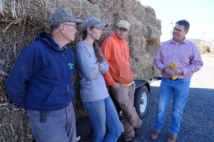 Virginia Secretary of Agriculture and Forestry stands with Extension volunteers during a hay donation day
