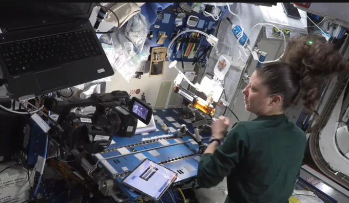 Astronaut on the International SPace Station working on one of the experiments