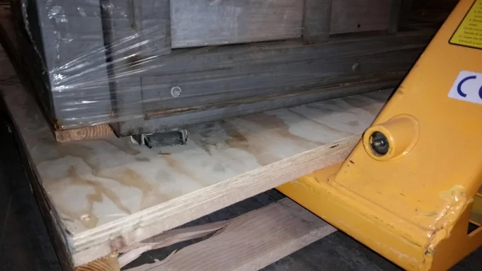 a nondescript, heavy mainframe computer on wheels that has accidentally broken into the pallet it was shipped on because it weighs a literal ton.