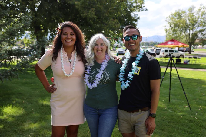 A Dean and graduate students stand smiling