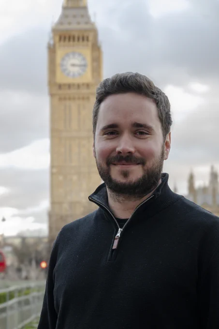 CAMRA Chairman Ash Corbett-Collins standing in front of Big Ben in London.