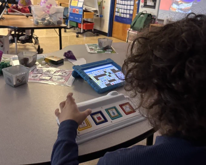 Student using 4 cell device to talk.