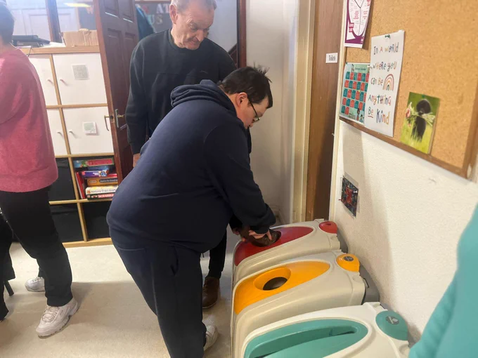 A gentleman doing the recycling