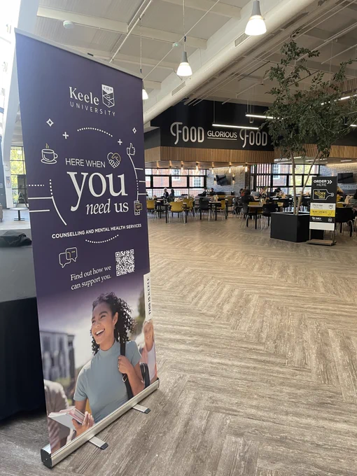A pull up banner in Chancellor's Building which says "Here when you need us. Counselling and Mental Health Services".