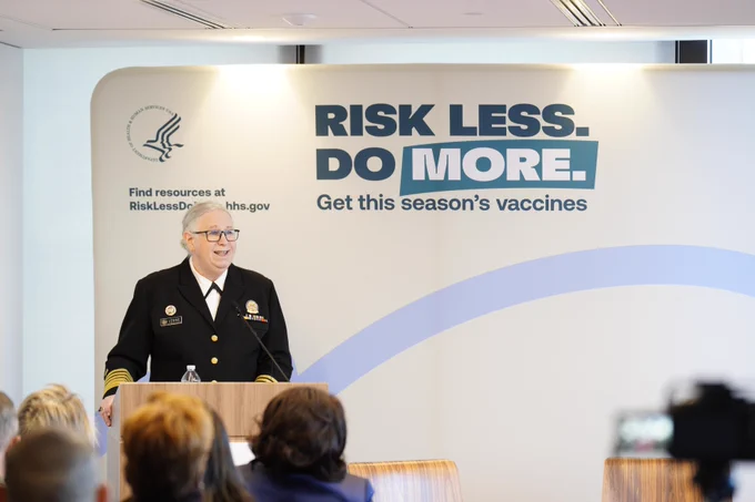 Photo of ADM Rachel Levine speaking at a podium in front of a "Risk Less. Do More." backdrop.