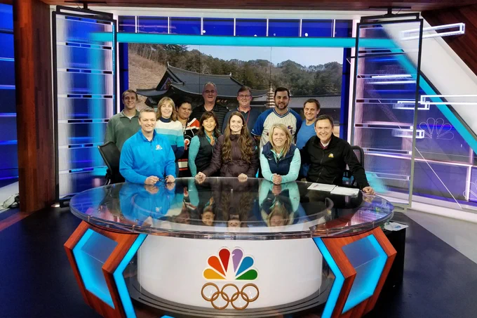 Bill smiles for a photo with other NBC Sports reporters for the Olympics