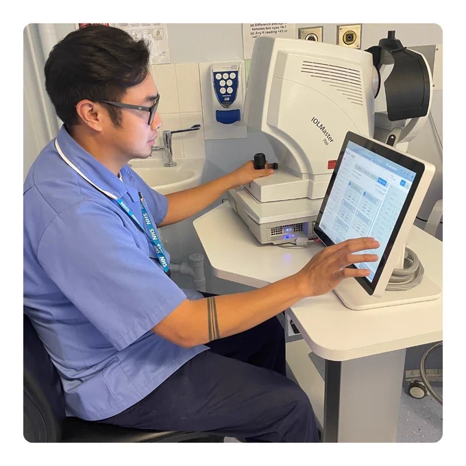 NHS staff using a machine. 
