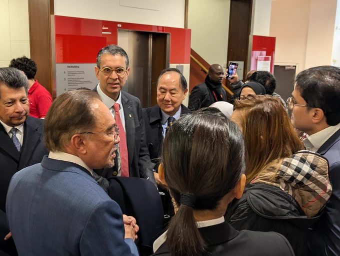 Prime Minister of Malaysia speaking to a group of students and alumni.
