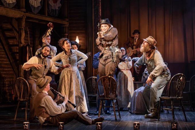 Carrie Hope Fletcher and the cast of Calamity Jane - they gather round playing instruments