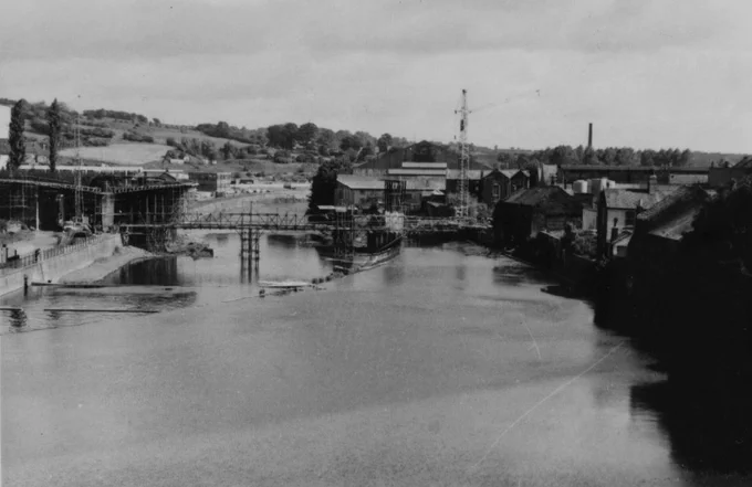 Black and white photograph of New Millburngate Bridge under construction in Durham. Showing the scaffolding over the river Wear. 