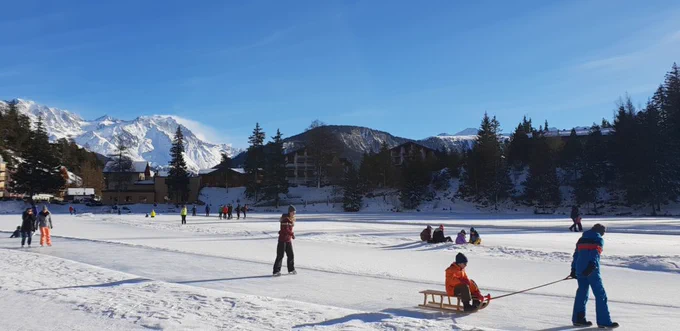 Leute gehen auf dem gefrorenen See verschiedenen winterlichen Tätigkeiten nach. (Bild: PaysStBernard)