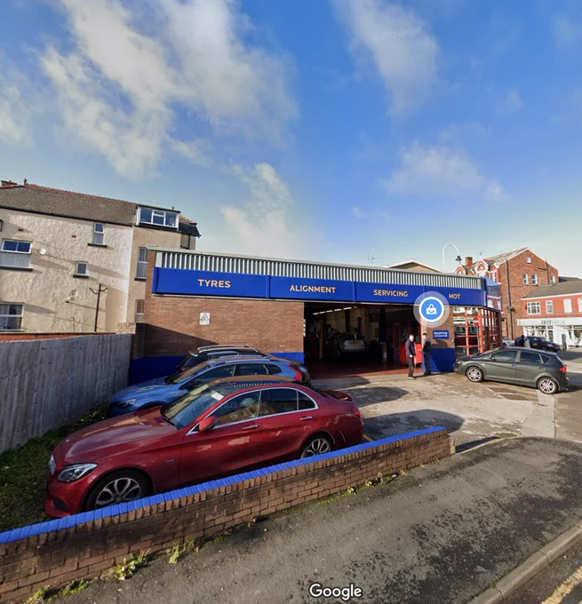 A colour photograph of the side of a Kwik Fit garage. Google Street view, November 2020.