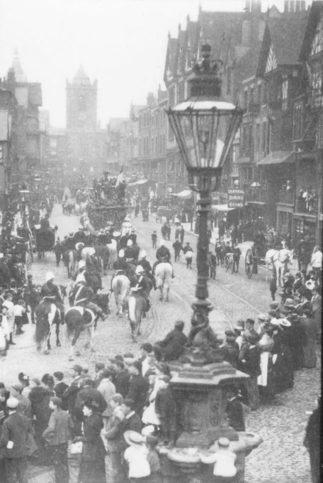 The History Hub's #SaturdayShot shows a Barnum and Bailey's circus parade down Bridge Street, #Chester in the 1890's. In the foreground of the photograph is the old drinking fountain. Lots of people are out watching the parade.