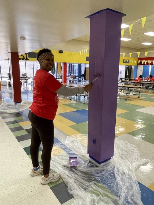 McDermott parent painting a cafeteria column