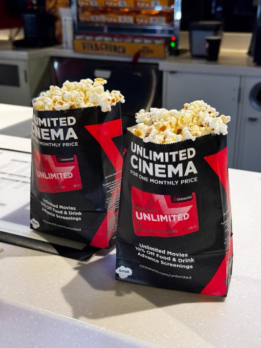 Two bags of popcorn on a counter, branded with "Unlimited Cinema for One Monthly Price," promoting the Cineworld Unlimited service.