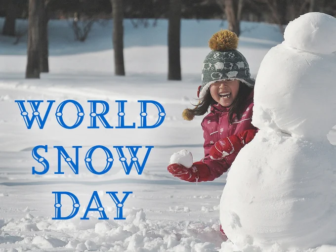A child wearing a winter jacket and hat smiling while standing next to a snowman, with the text "World Snow Day" overlaid in blue.