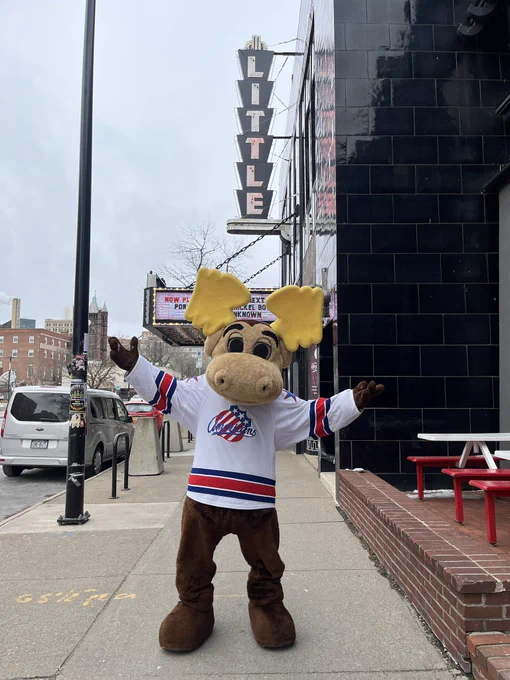 A moose mascot in front of The Little