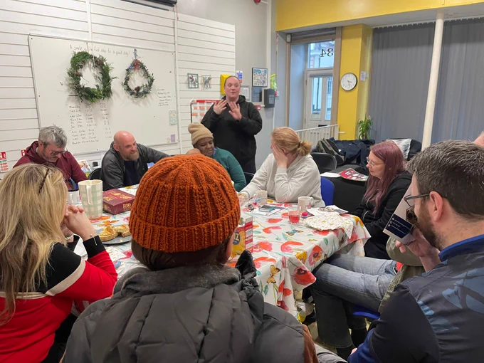 A group of people engage in activity and conversation.