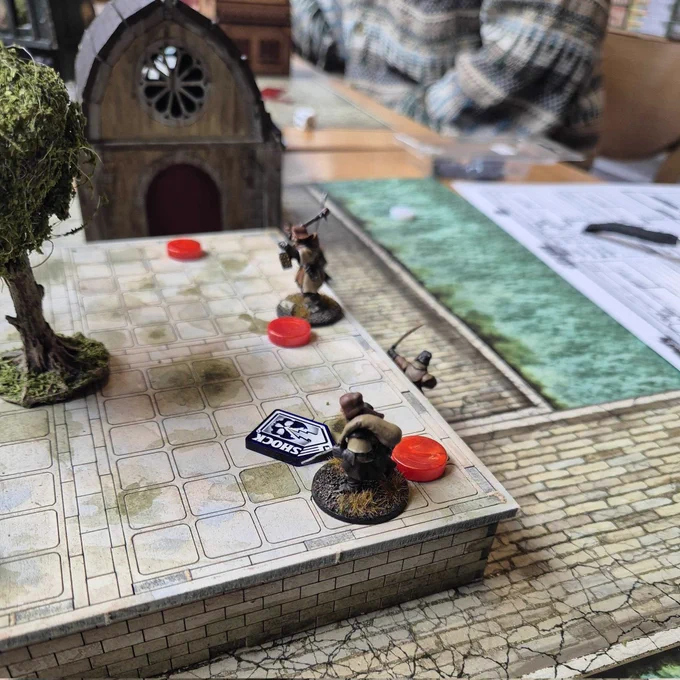 A game of Forbidden Psalm being played in the Edinburgh board game shop Ancient Robot Games.