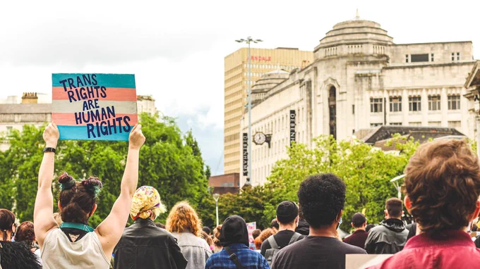protester in crowd holding up transgender flag with blue, pink and white stripes and the words 'trans rights are human rights' written across it

Image Credit: Oriel Frankie Ashcroft via Pexels - https://www.pexels.com/photo/people-standing-and-holding-blue-and-white-banner-6054385/