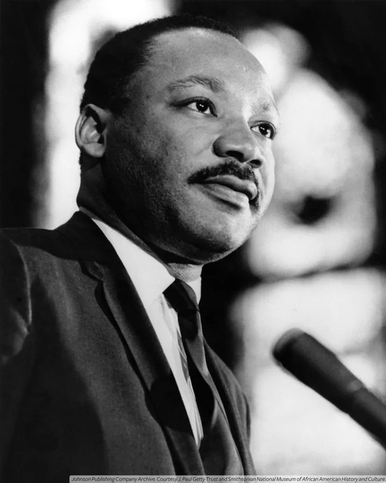 A black-and-white photograph close-up of Dr. Martin Luther King.