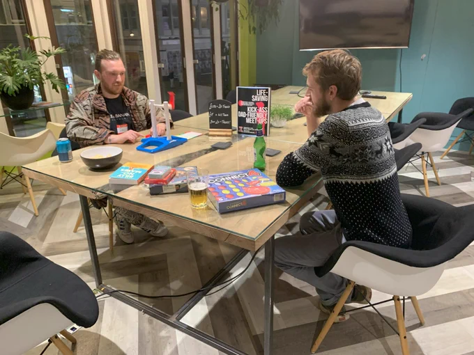 Two dads play games together and engage in conversation