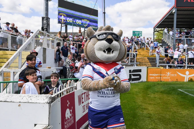 Wakefield Trinity Rugby League Mascot on the pitch surrounded by fans