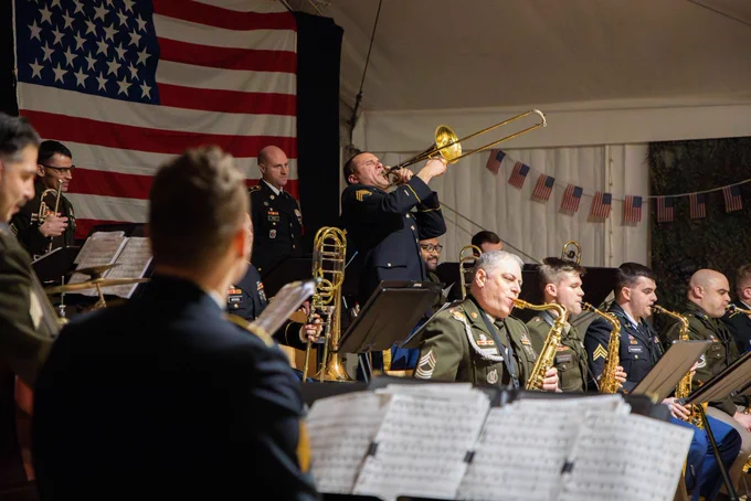 US Army soldier playing a trumpet enthusiastically 
