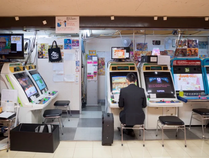 A old japanese game center with only one person playing.
