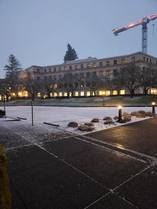 A light layer of snow blanketing the Capitol Campus parking lot. 