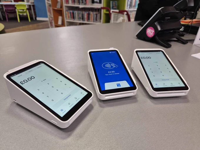 Three new card & contactless machines laid out on the staff desk at Central Library.
