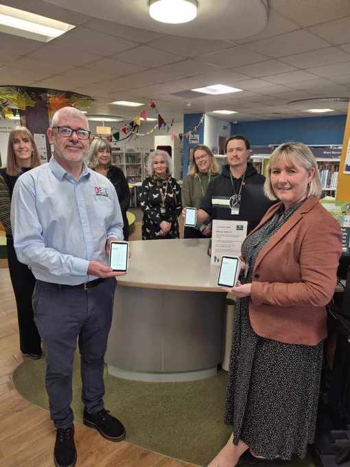Staff at Central Library showing off the new chip & PIN machines. Including Joe from Delt, and Cllr Sally Haydon holding the device terminals.