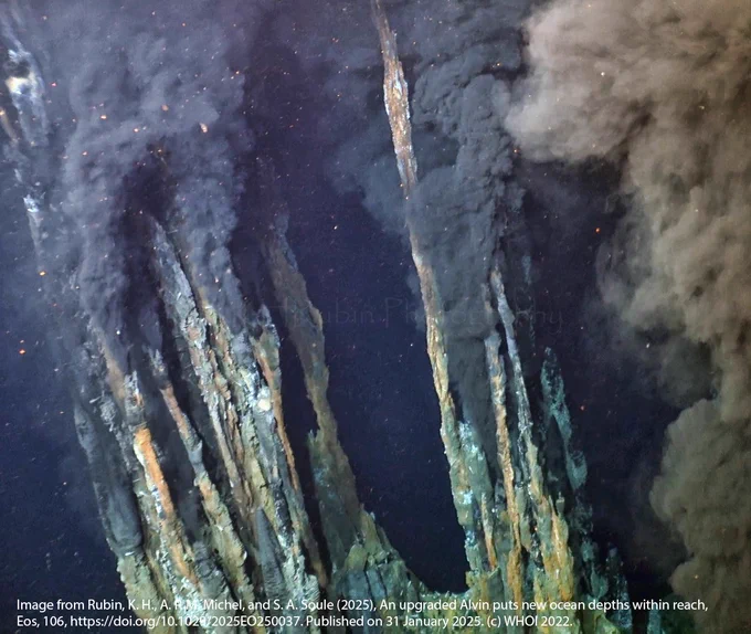 Tall, thin, spindly black smoker chimneys emit unusually high Copper fluids, at Earth’s deepest known hydrothermal vent field, alternatively referred to as the Piccard or Beebe field in the literature, 5000m below sea level on the Mid Cayman Rise. This image was captured from 4K video, cropped,  and color & sharpness corrected by Kenna Harmony Rubin. Source: Rubin, K. H., A. P. M. Michel,  & S. A. Soule (2025), An upgraded Alvin puts new ocean depths within reach, Eos, 106, https://doi.org/10.1029/2025EO250037. Published on 31 January 2025. https://eos.org/science-updates/an-upgraded-alvin-puts-new-ocean-depths-within-reach . Image Credit: Courtesy of S. Adam Soule, WHOI/NSF/HOV Alvin/2022, ©Woods Hole Oceanographic Institution