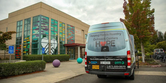Image of the Bybee Lakes Hope Center building with a van in the frame