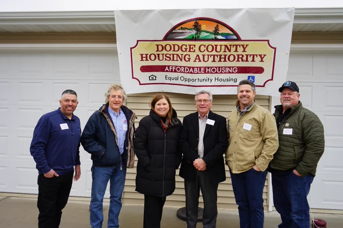 Secretary Kathy Blumenfeld posing for photo with stakeholders of the Dodge County Housing Authority's affordable housing development in the City of Juneau. 