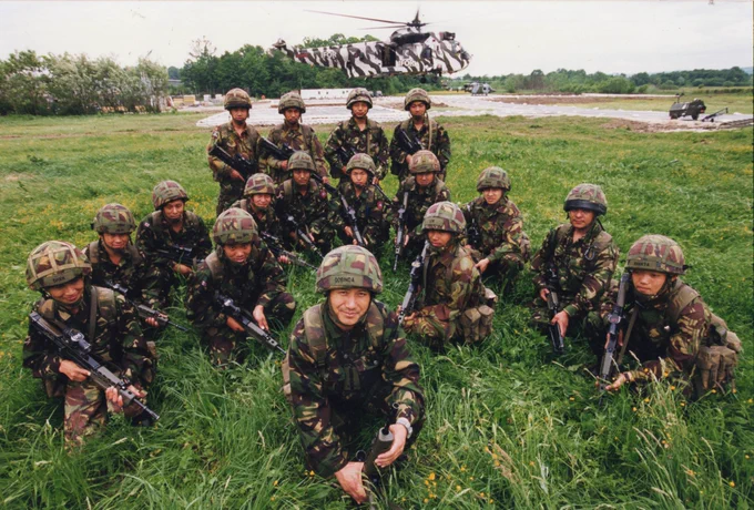 Gurkha soldiers gathered in a field