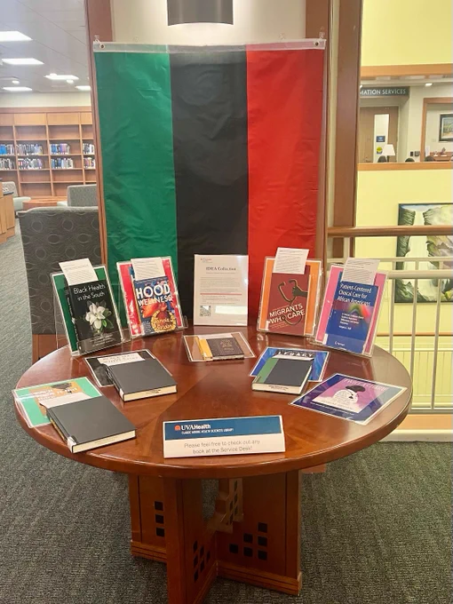the Pan African Flag behind a display of books on a table 