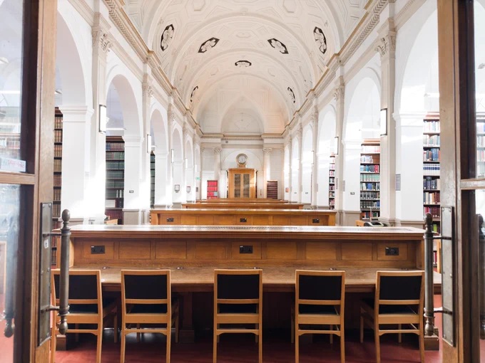 Study spaces in between rows of bookshelves at the Donaldson Reading Room.