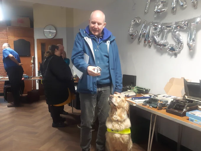 Image of Paul and Pyrgo looking at Braille equipment 