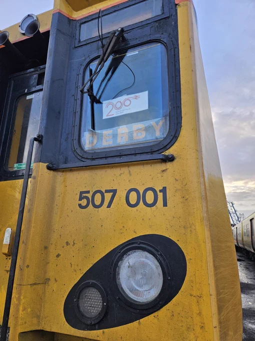 Close up of 507001. In the cab windscreen is a Railway200 logo and “DERBY” in yellow letters 