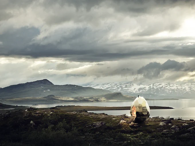 a sauna in the shape of a golden egg on a beach in northern Sweden