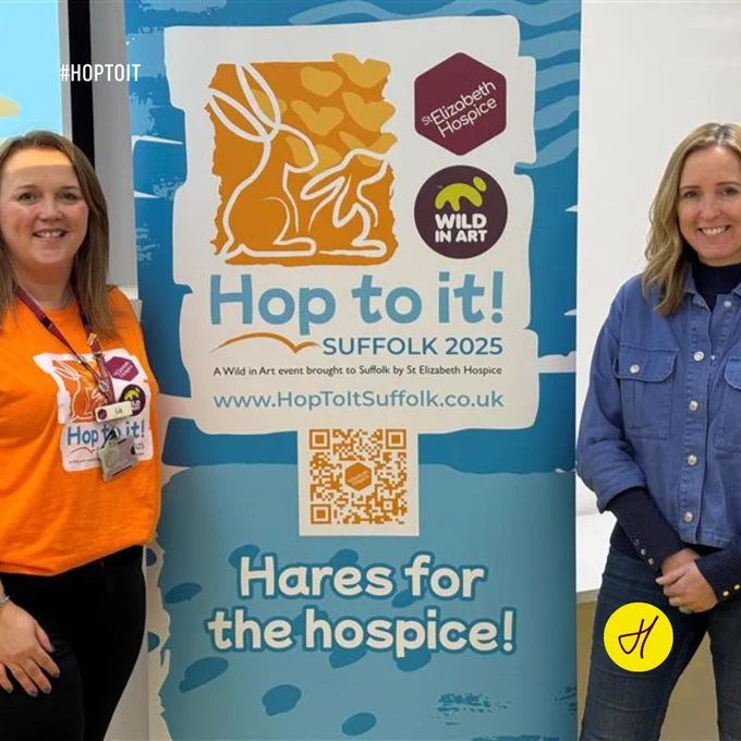 Liz Baldwin of St Elizabeth Hospice (L) with Lucy Parish, Hopestead head of operations, in front of the Hop to it! promotional banner at an event in Ipswich 