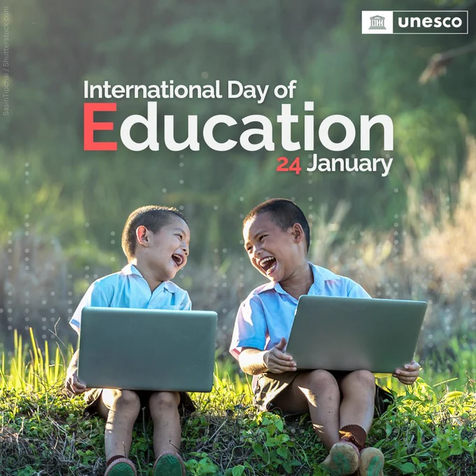 Promotional image for the International Day of Education, celebrated on 24 January. The image shows two young children sitting outdoors on a grassy field, laughing joyfully while holding laptops. The background is a blurred natural setting with sunlight filtering through. The text 'International Day of Education, 24 January' is prominently displayed, with the UNESCO logo in the top-right corner.