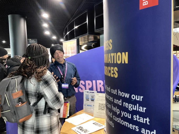 A business advisor engages with a member of the public.