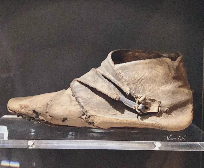 A well-preserved Anglo-Scandinavian leather ankle shoe, fastened with a double flap and toggles mounted one on each of two individual flaps. 10th-century AD. The excavations at 16–22 Coppergate recovered nineteen shoes of this style of shoe with double flap and toggles.