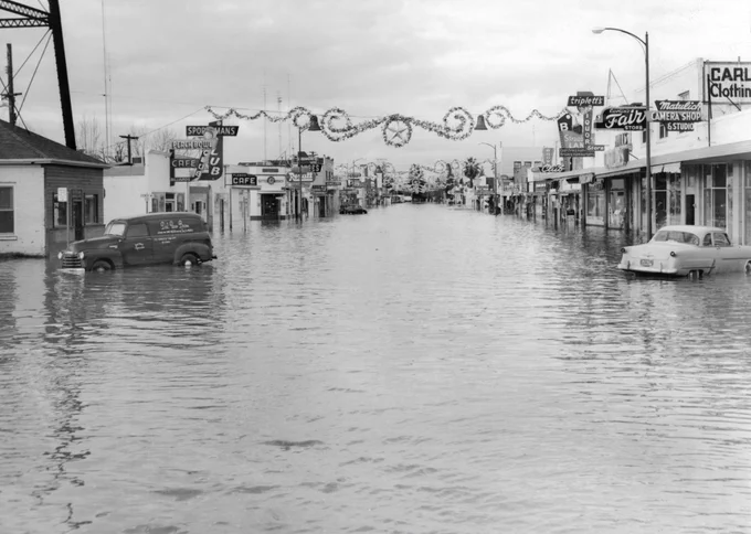 Image and caption from blog: "This view looks north on Plumas Street, just north of Bridge Street in the heart of the Yuba City, California business district. The massive Northern California flood of 1955 remains the deadliest to hit the Yuba City and Marysville region. 38 were killed, 280 homes were destroyed and over 1500 were damaged. The Shanghai Bend on the west levee of the Feather River, about one mile south of Yuba City was breached around midnight on Christmas Eve, and a wall of water cascaded into Sutter County, which forced thousands of residence to evacuate their homes. Photo taken December 25, 1955. 
Courtesy photo U.S. Force 136th Engineer Aviation Brigade from Beale Air Force Base / Content obtained from California Department of Water Resources."