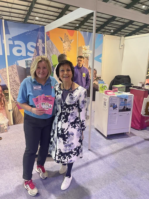 Holiday World Dublin 2025 Visit Belfast stand with Visit Ards and North Down, High Rise Lisburn (background) and Maureen, Holiday World organiser