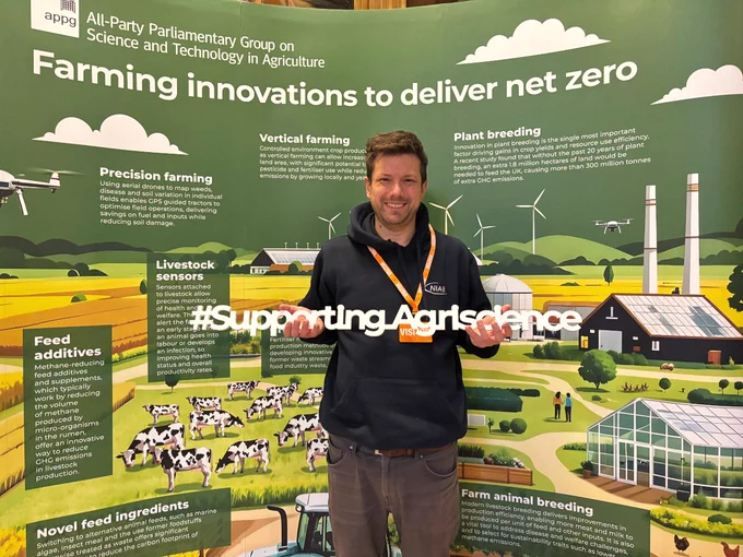 Man holding #SupportingAgriscience banner
